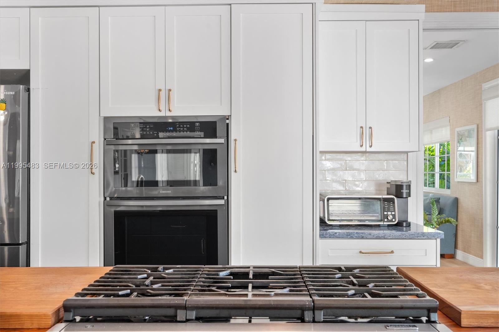 9636 Northeast 5th Avenue Road Miami Shores, FL 33138 - Photo 37 of 86 a stove top oven sitting inside of a kitchen