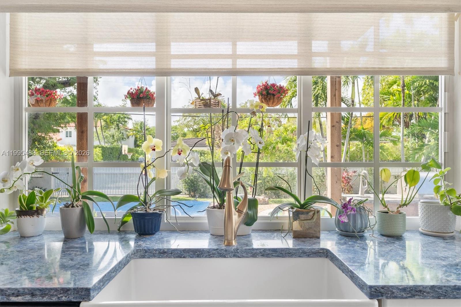 9636 Northeast 5th Avenue Road Miami Shores, FL 33138 - Photo 38 of 86 a vase of flowers sitting on a table with window