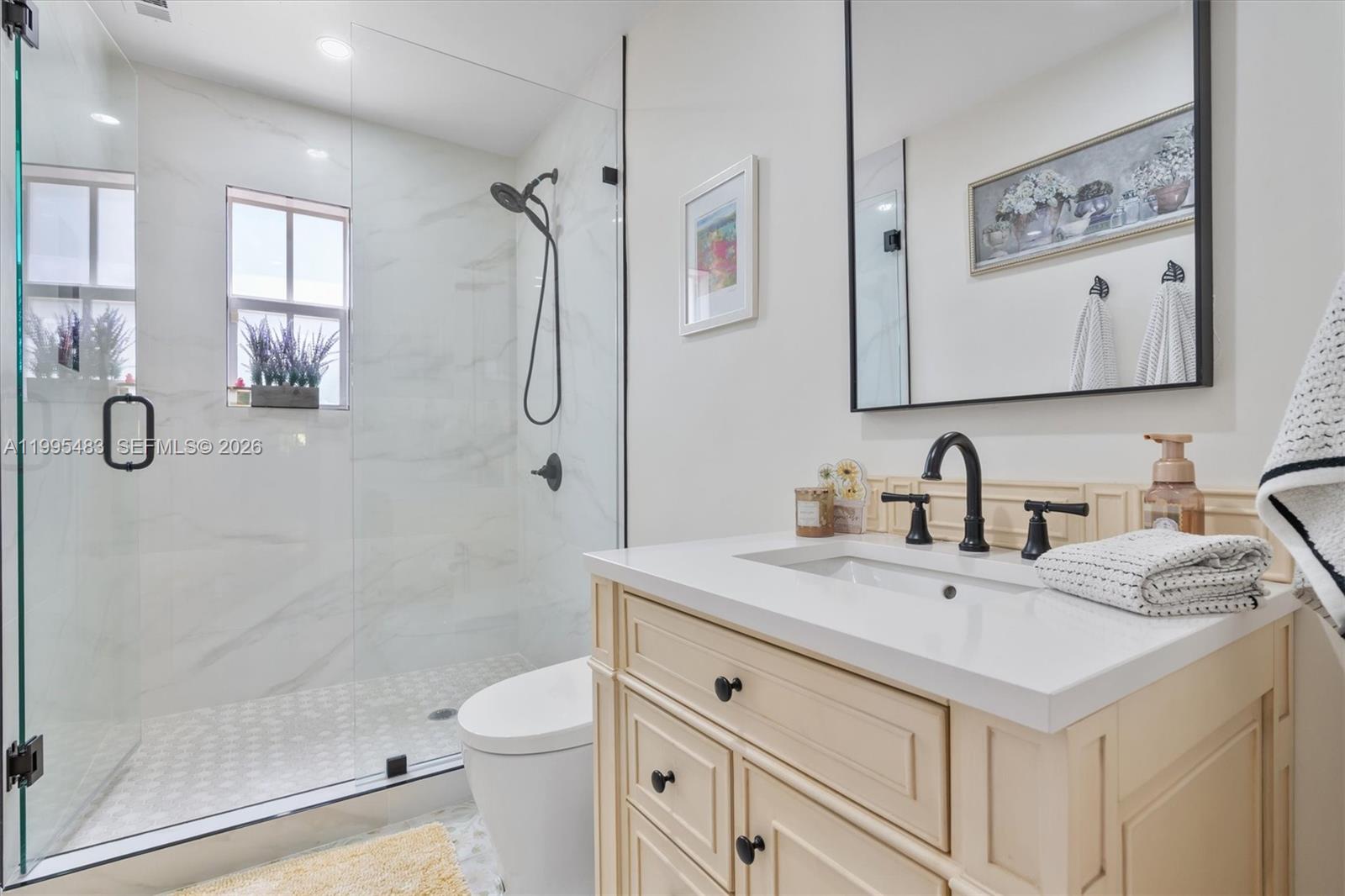9636 Northeast 5th Avenue Road Miami Shores, FL 33138 - Photo 46 of 86 a bathroom with a granite countertop sink mirror vanity and toilet