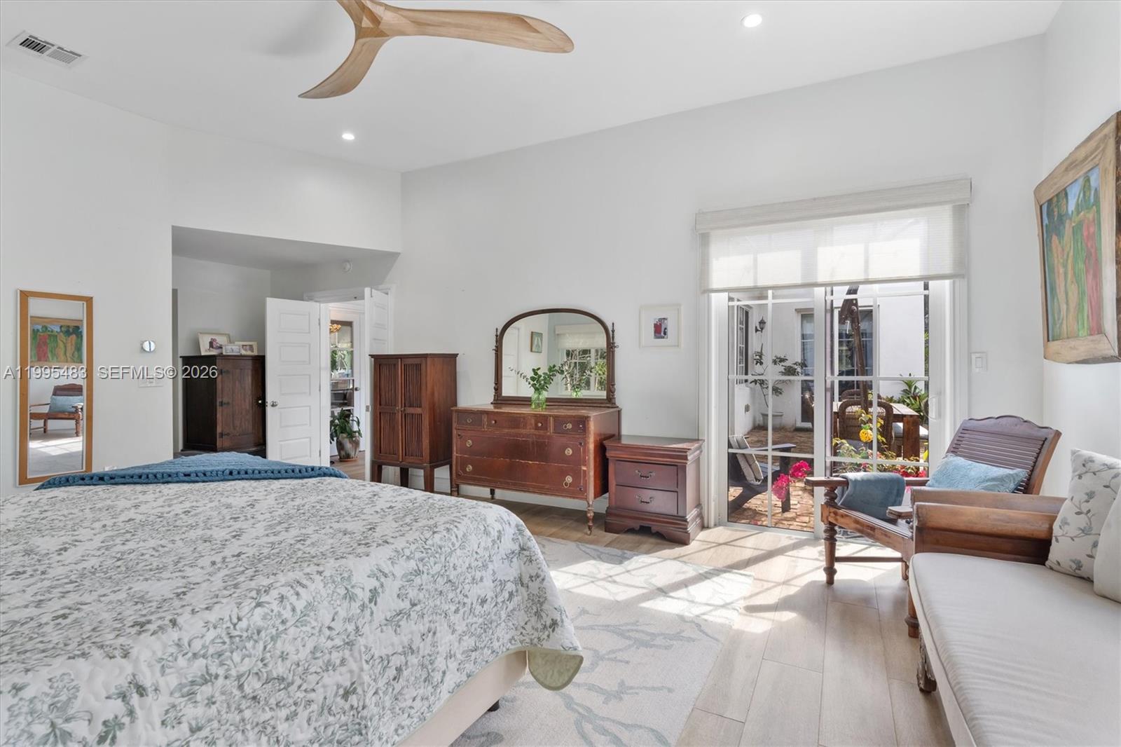 9636 Northeast 5th Avenue Road Miami Shores, FL 33138 - Photo 50 of 86 a bedroom with a bed large window and couch