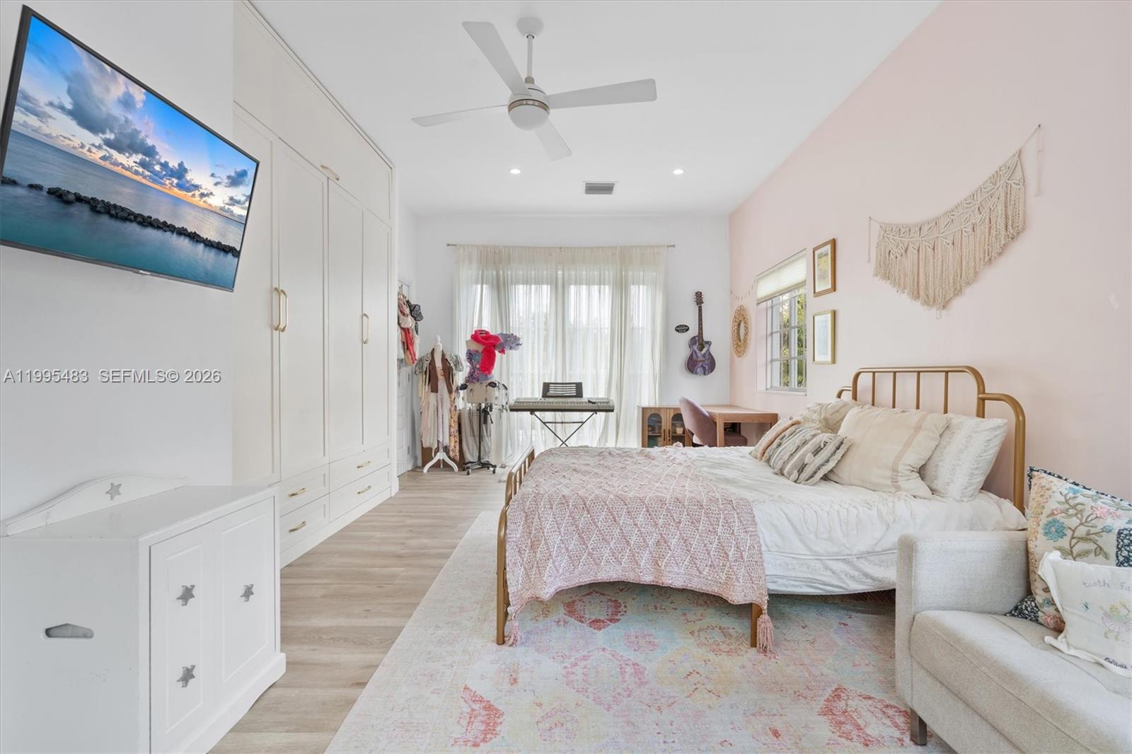 9636 Northeast 5th Avenue Road Miami Shores, FL 33138 - Photo 64 of 86 a spacious bedroom with a bed couch and a window