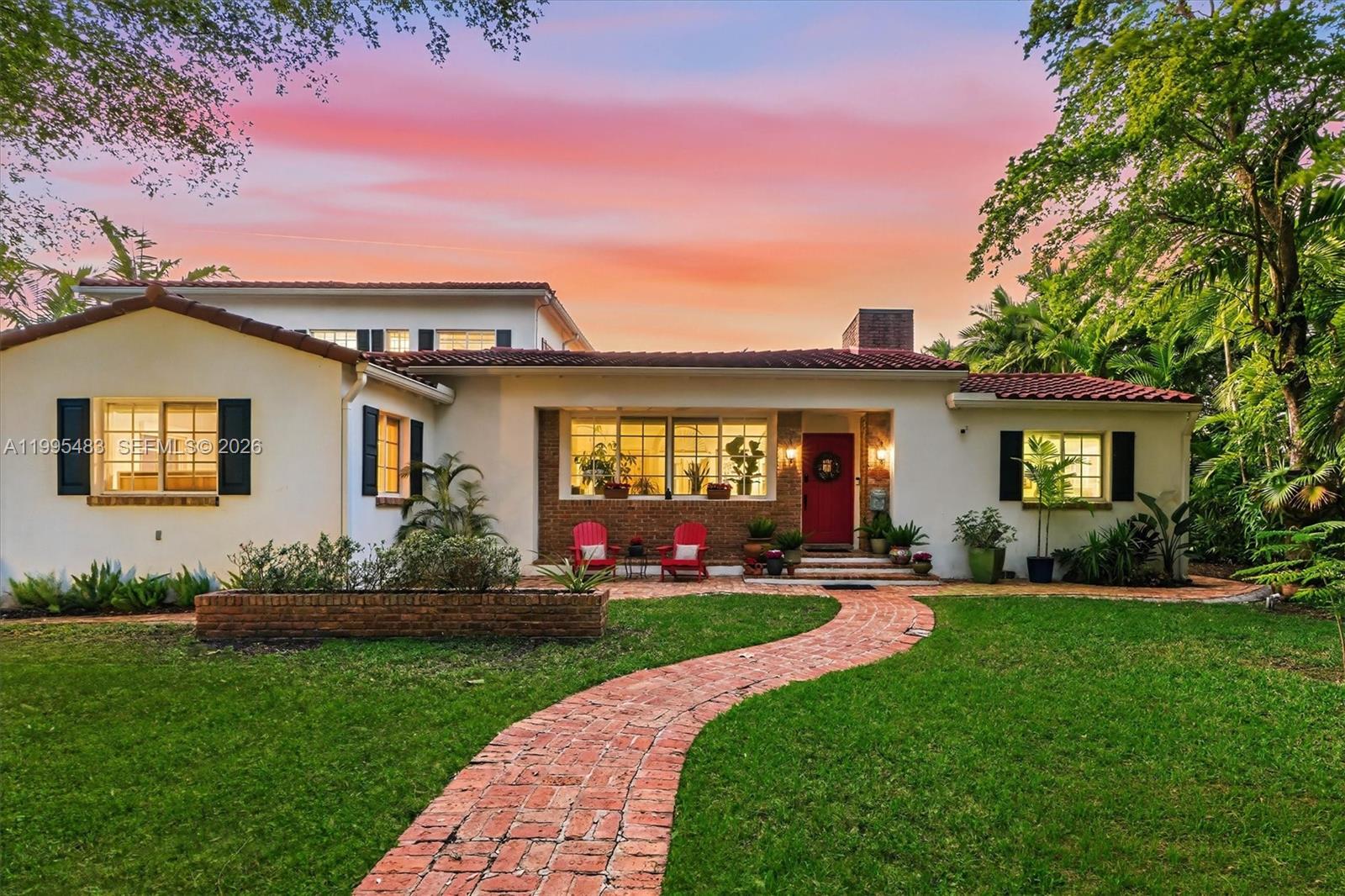 9636 Northeast 5th Avenue Road Miami Shores, FL 33138 - Photo 7 of 86 a front view of a house with a garden and plants