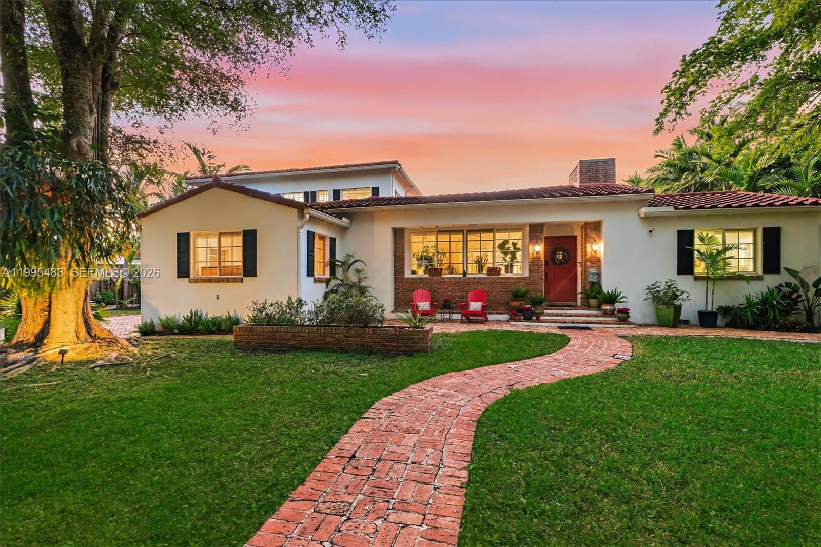 9636 Northeast 5th Avenue Road Miami Shores, FL 33138 - Photo 8 of 86 a front view of a house with yard and green space