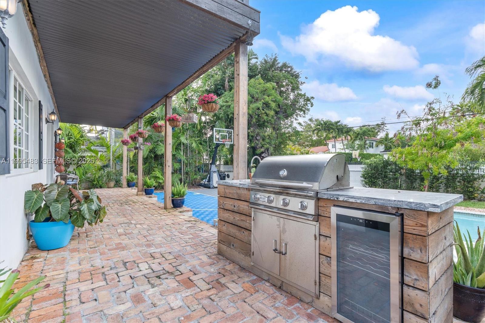 9636 Northeast 5th Avenue Road Miami Shores, FL 33138 - Photo 86 of 86 a view of a patio with table and chairs potted plants with wooden floor