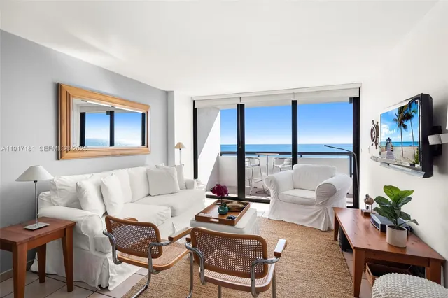 a living room with furniture a flat screen tv and a large window