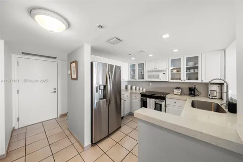 a kitchen with stainless steel appliances granite countertop a refrigerator and a stove top oven