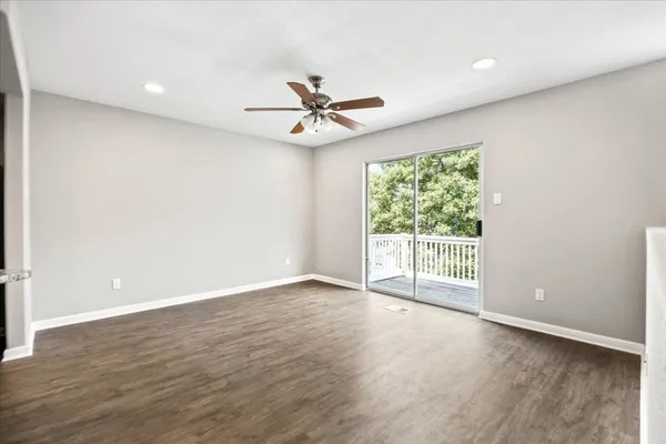 a view of a room with wooden floor and staircase
