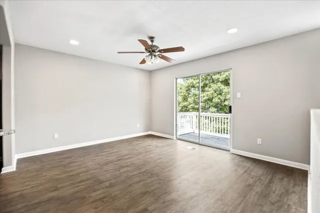 a view of a room with wooden floor and staircase