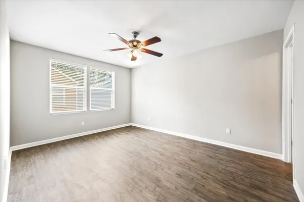 a backyard of a house with barbeque oven and trees