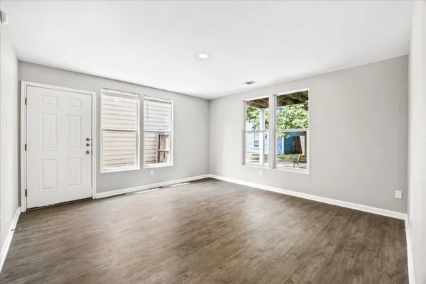 an aerial view of house with yard and mountain view in back