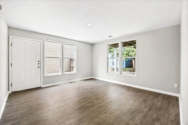 an aerial view of house with yard and mountain view in back