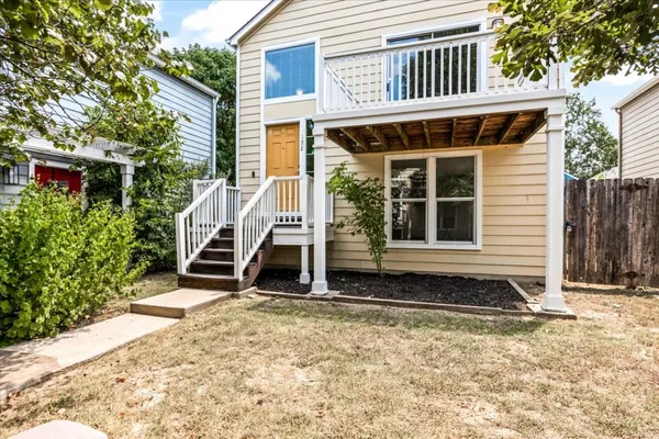 a view of a kitchen with a sink and dishwasher a refrigerator with wooden floor