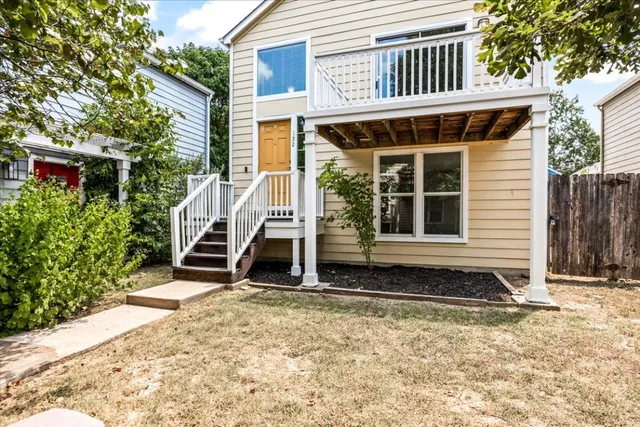 a view of a kitchen with a sink and dishwasher a refrigerator with wooden floor