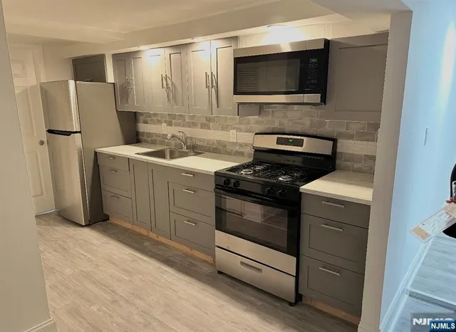 a kitchen with a refrigerator stove and microwave