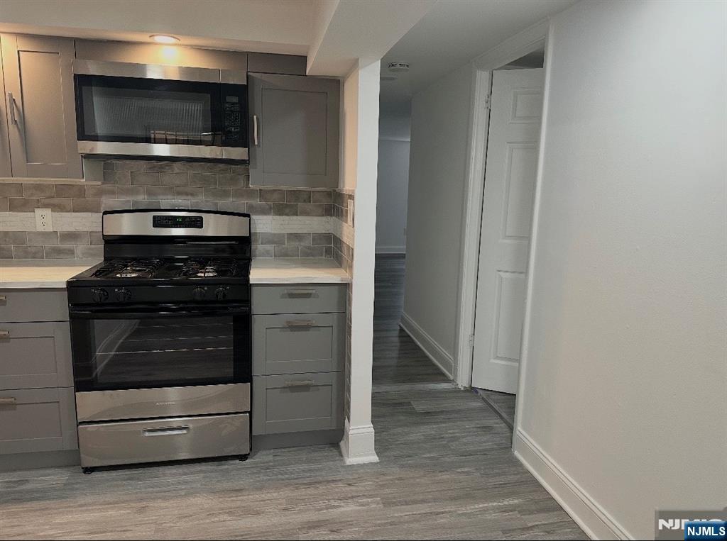 7810 3rd Avenue North Bergen, NJ 07047 - Photo 2 of 13 a kitchen with a stove and a microwave