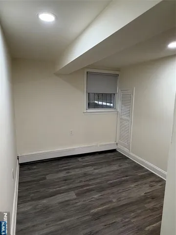 a view of an empty room and wooden floor
