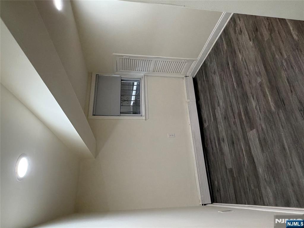 7810 3rd Avenue North Bergen, NJ 07047 - Photo 4 of 13 a view of an empty room and wooden floor