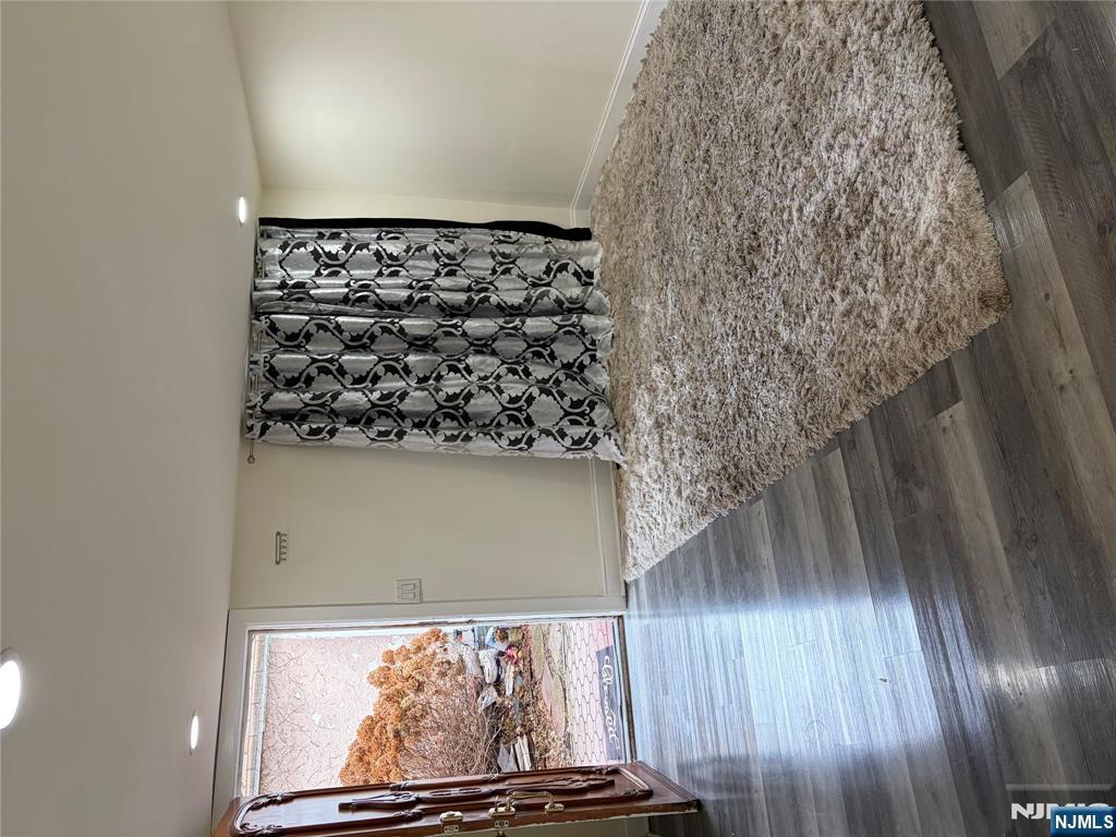 7810 3rd Avenue North Bergen, NJ 07047 - Photo 5 of 13 a view of a floor to ceiling window and wooden floor