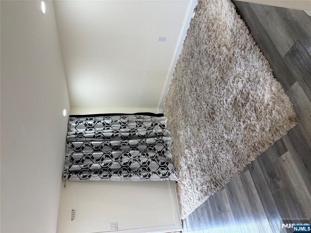 7810 3rd Avenue North Bergen, NJ 07047 - Photo 6 of 13 a view of a livingroom with wooden floor and bench in it