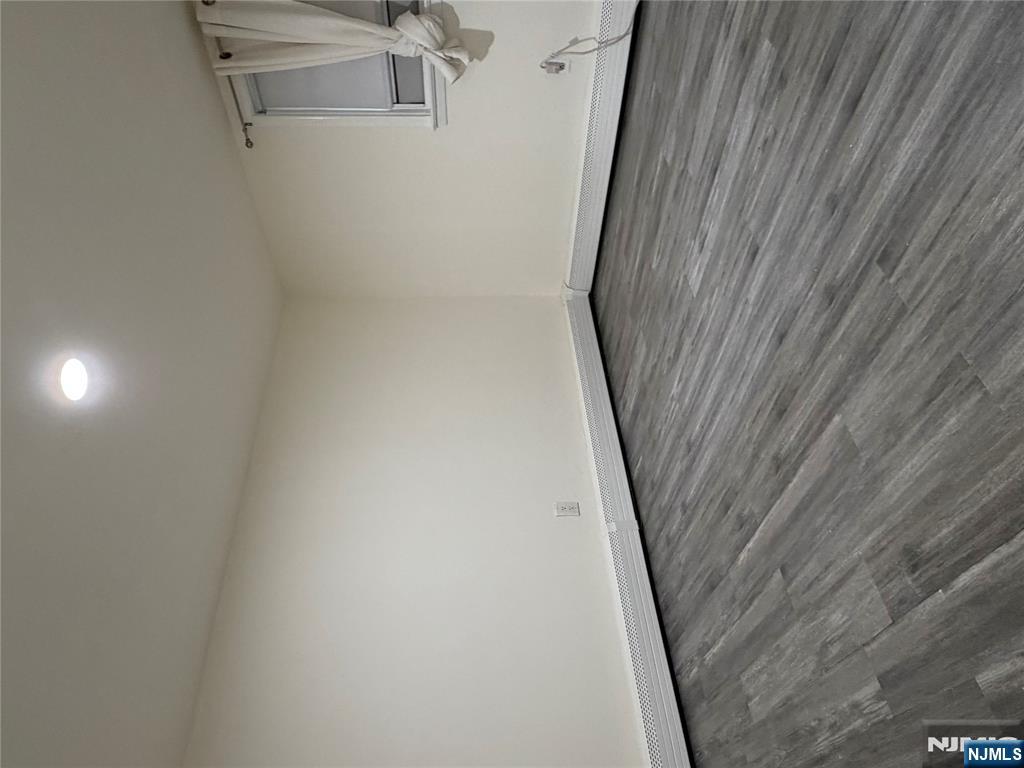 7810 3rd Avenue North Bergen, NJ 07047 - Photo 9 of 13 wooden floor in an empty room