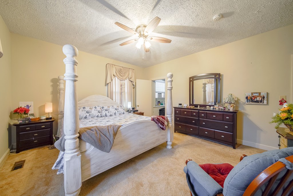 410 3rd Street Manchester, GA 31816 - Photo 16 of 45 a bedroom with a bed and wooden floor