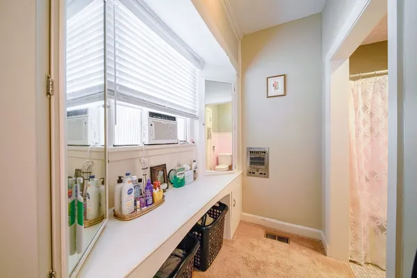 a bathroom with a sink a toilet and a mirror