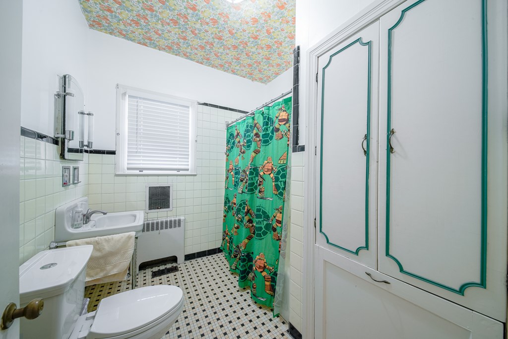 410 3rd Street Manchester, GA 31816 - Photo 23 of 45 a white toilet sitting next to a bathroom sink