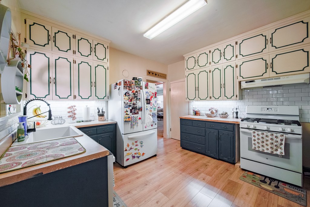 410 3rd Street Manchester, GA 31816 - Photo 29 of 45 a kitchen with stainless steel appliances granite countertop a stove and cabinets