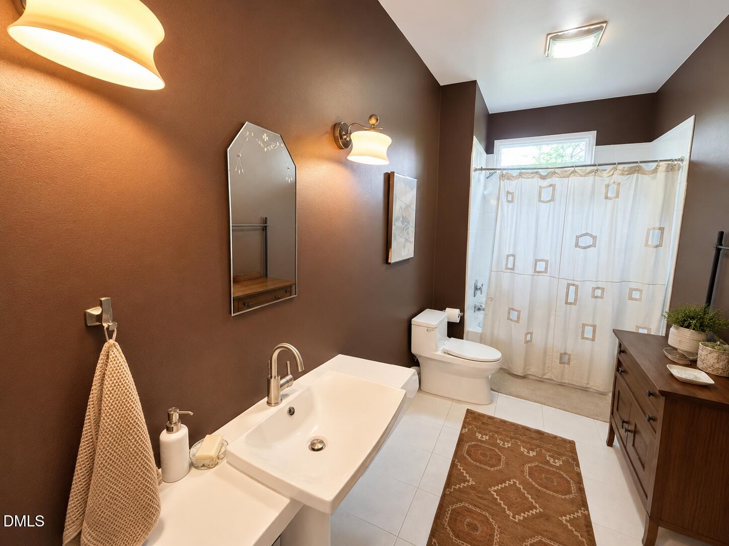 2200 Kilburn Road Raleigh, NC 27604 - Photo 18 of 21 a bathroom with a sink a toilet and shower