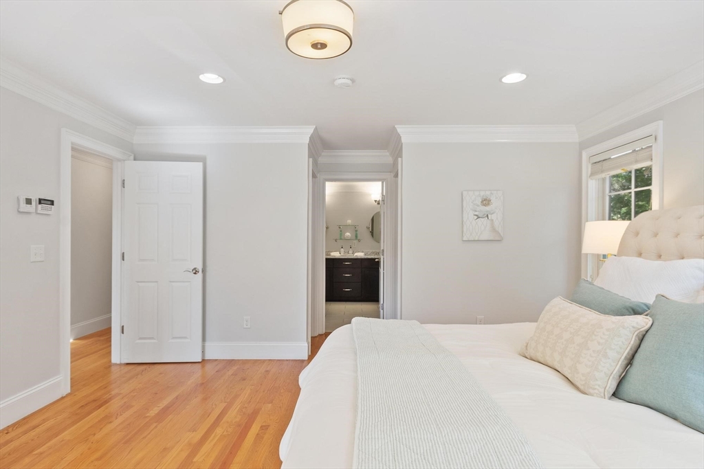 56 Old Marlboro Road Concord, MA 01742 - Photo 10 of 34 a bedroom with a large bed and chandelier