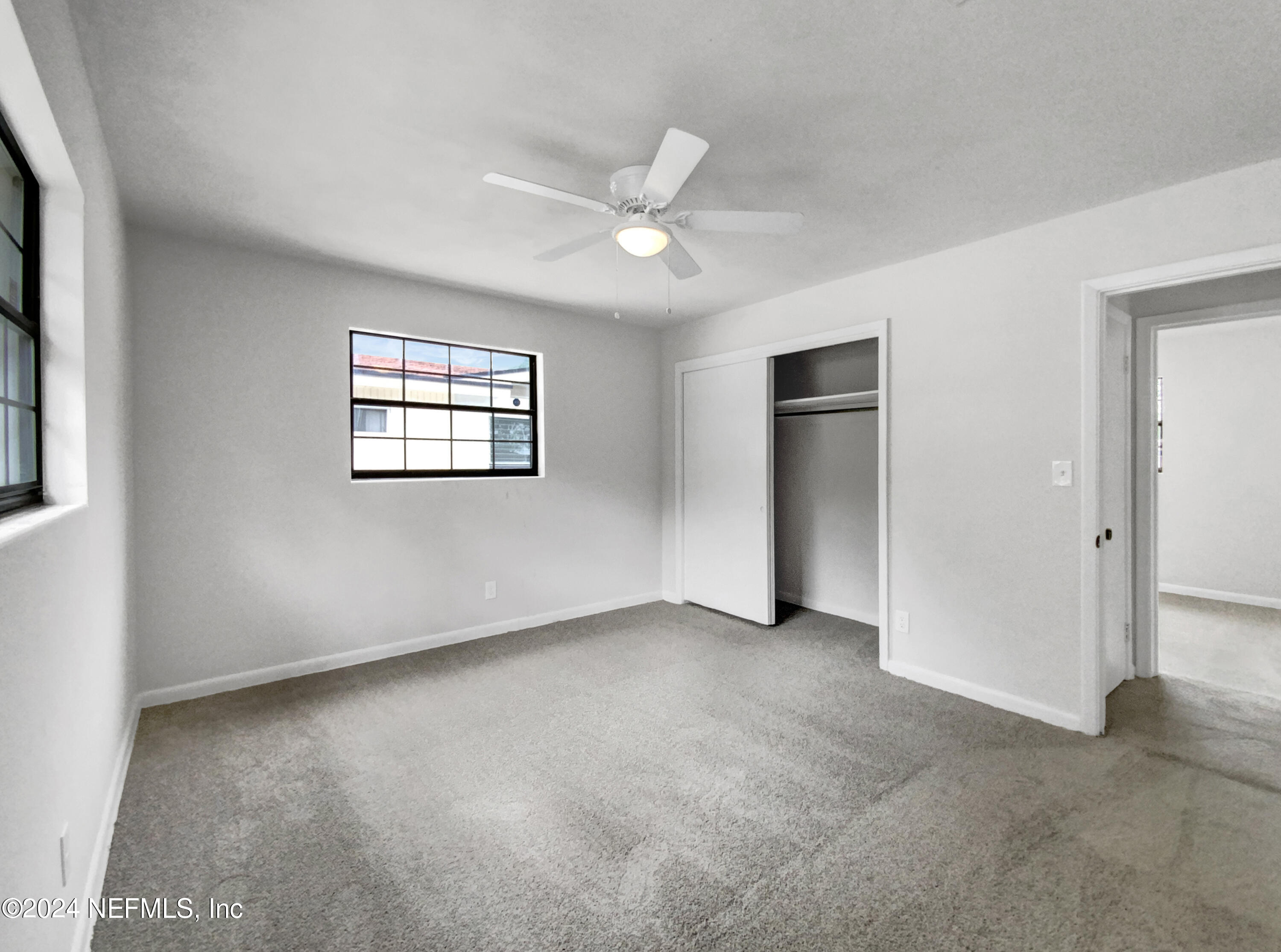 2716 Sam Road Jacksonville, FL 32216 - Photo 3 of 20 an empty room with windows and closet