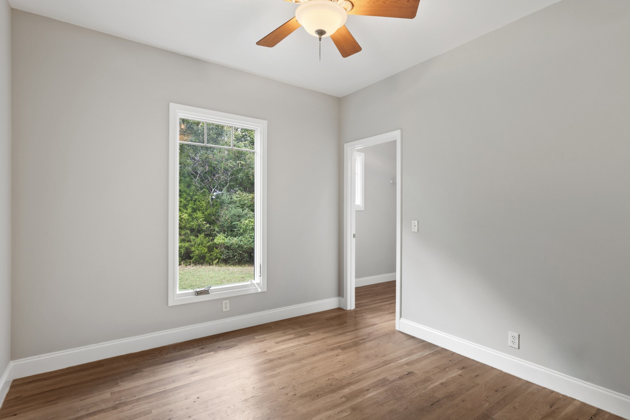 2294 Daniels Road Greenbrier, TN 37073 - Photo 16 of 52 an empty room with wooden floor chandelier and window