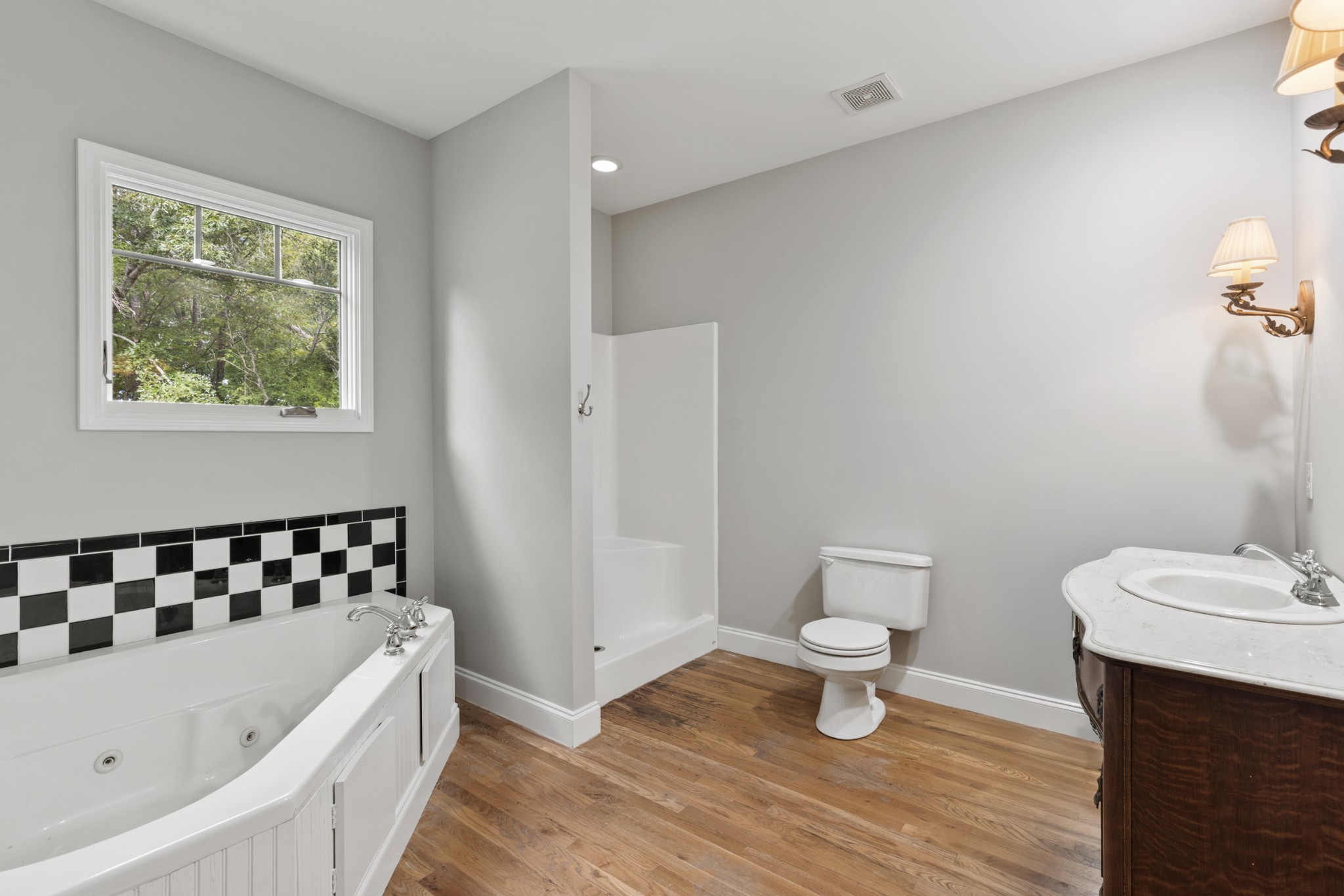 2294 Daniels Road Greenbrier, TN 37073 - Photo 29 of 52 a bathroom with a bathtub a sink a toilet and a window