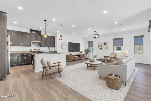 a living room with lots of furniture and kitchen view