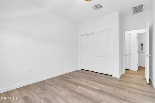 an empty room with wooden floor