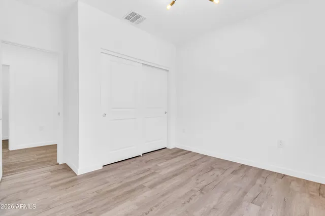 an empty room with wooden floor