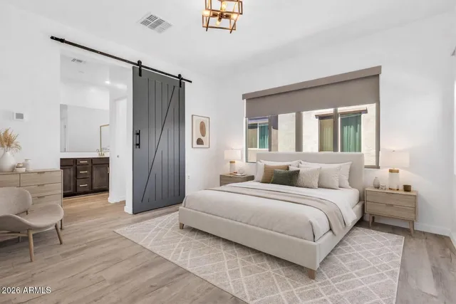 a bedroom with a bed furniture and a large window