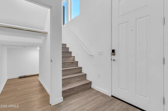 a view of a hallway with wooden floor and entryway