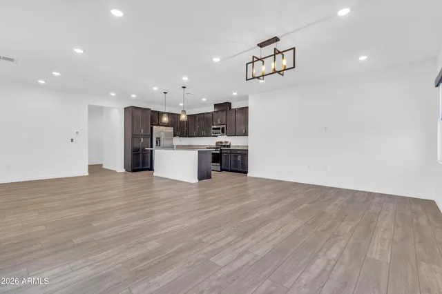 a view of a kitchen with a sink and a refrigerator