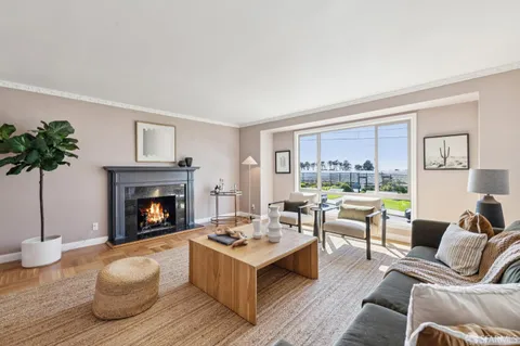 a view of a dining room with furniture a chandelier and wooden floor