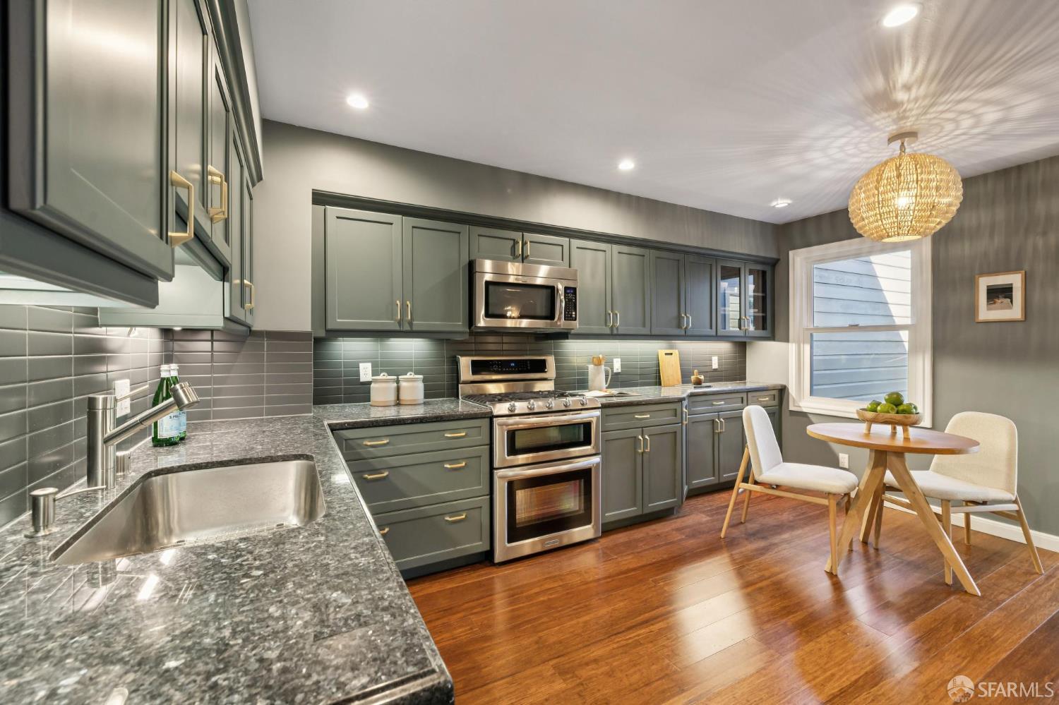 1942 24th Avenue San Francisco, CA 94116 - Photo 23 of 84 a kitchen with a sink stainless steel appliances and cabinets