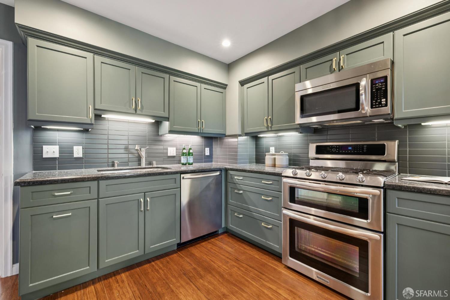 1942 24th Avenue San Francisco, CA 94116 - Photo 25 of 84 a kitchen with stainless steel appliances granite countertop a stove microwave and sink