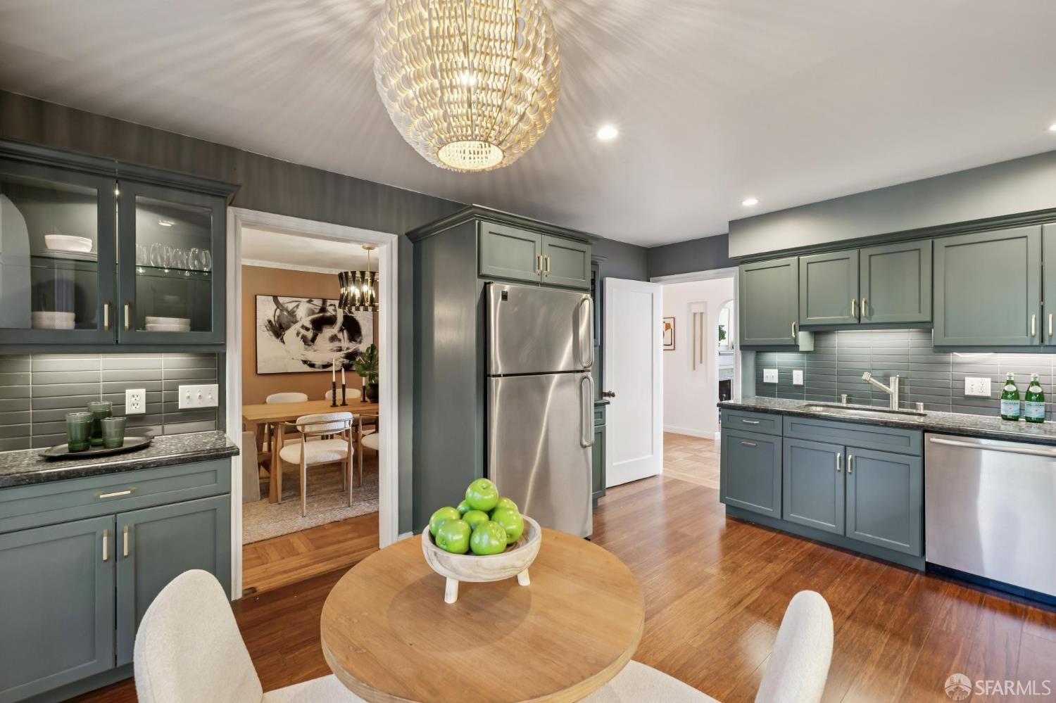 1942 24th Avenue San Francisco, CA 94116 - Photo 27 of 84 a kitchen with stainless steel appliances granite countertop a refrigerator a sink a stove a dining table and chairs