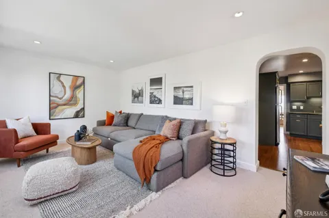 a living room with furniture and a potted plant