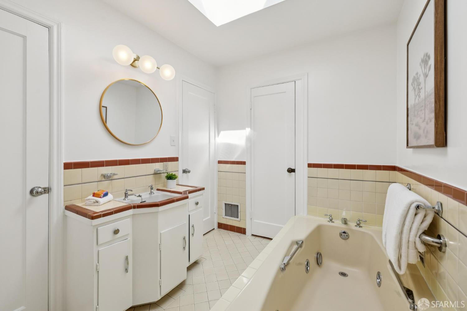 1942 24th Avenue San Francisco, CA 94116 - Photo 50 of 84 a bathroom with a sink and a mirror