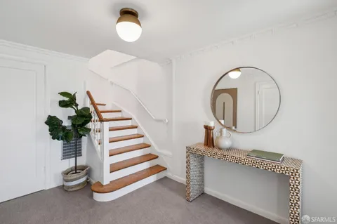 a living room with furniture and a mirror