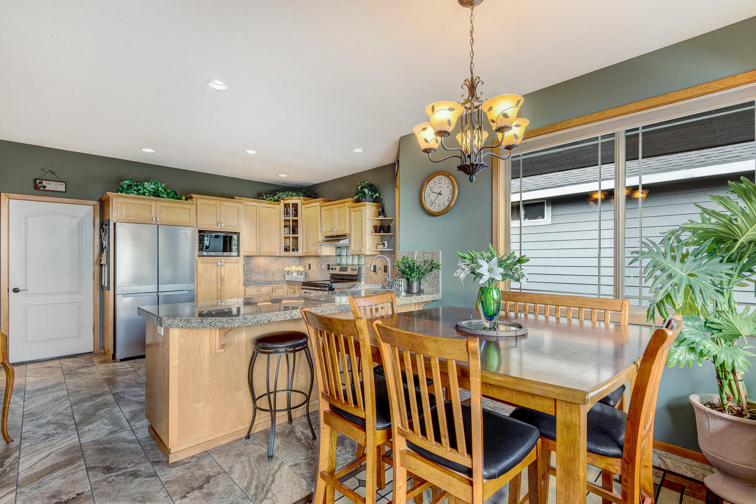 2434 Southwest 34th Drive Redmond, OR 97756 - Photo 11 of 36 a view of a dining room and kitchen with a table chairs and chandelier
