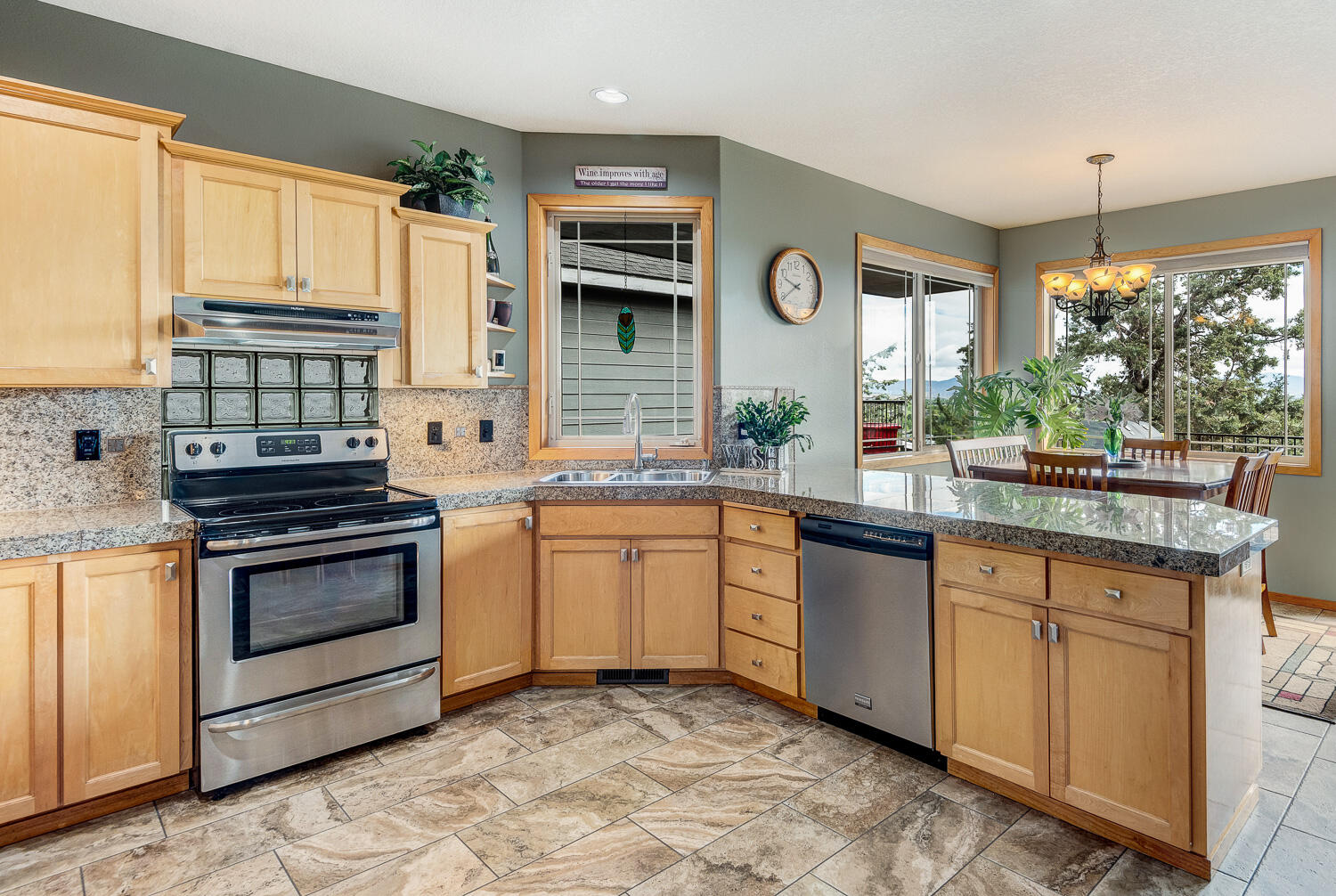 2434 Southwest 34th Drive Redmond, OR 97756 - Photo 14 of 36 a kitchen with stainless steel appliances granite countertop a stove a sink and a microwave