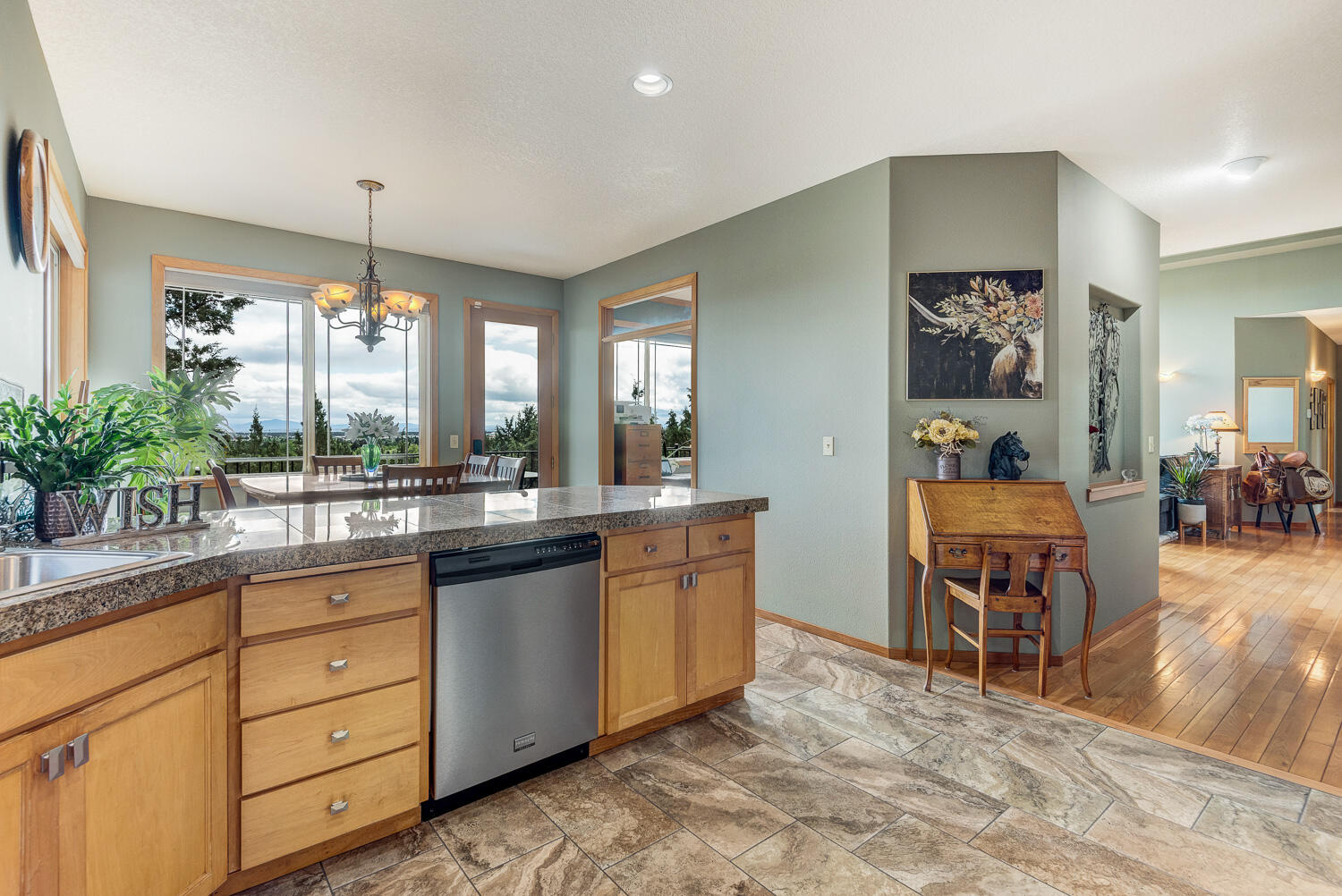 2434 Southwest 34th Drive Redmond, OR 97756 - Photo 16 of 36 a large kitchen with kitchen island granite countertop a large counter space and stainless steel appliances