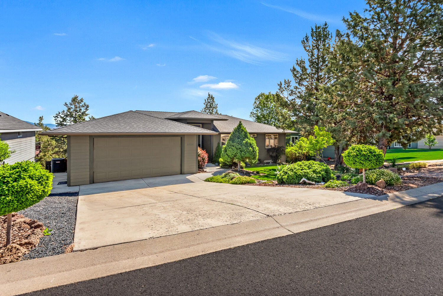 2434 Southwest 34th Drive Redmond, OR 97756 - Photo 35 of 36 a front view of a house with a yard and a garage